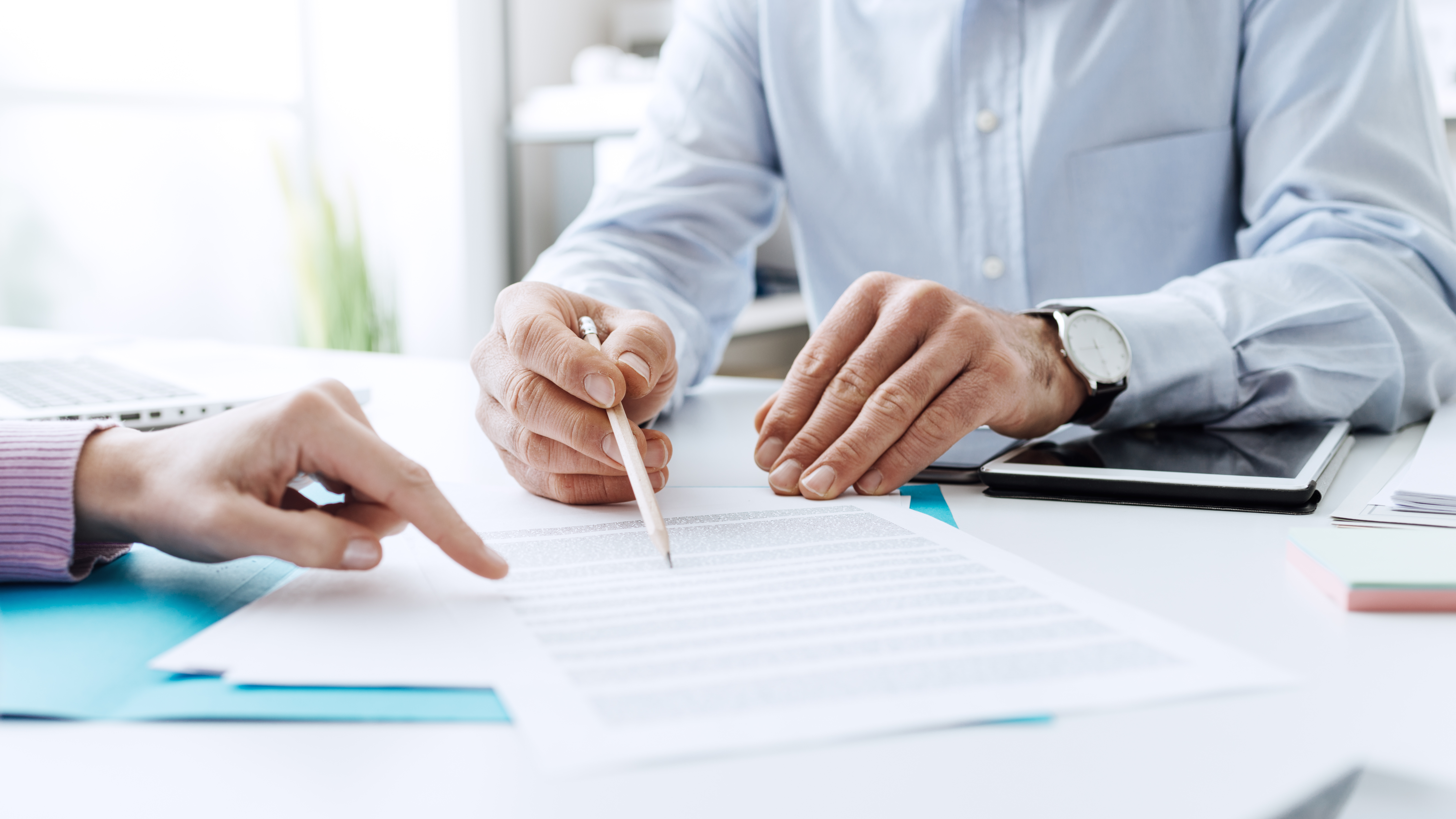 hands of two people going over important documents