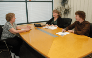 three women in conference room